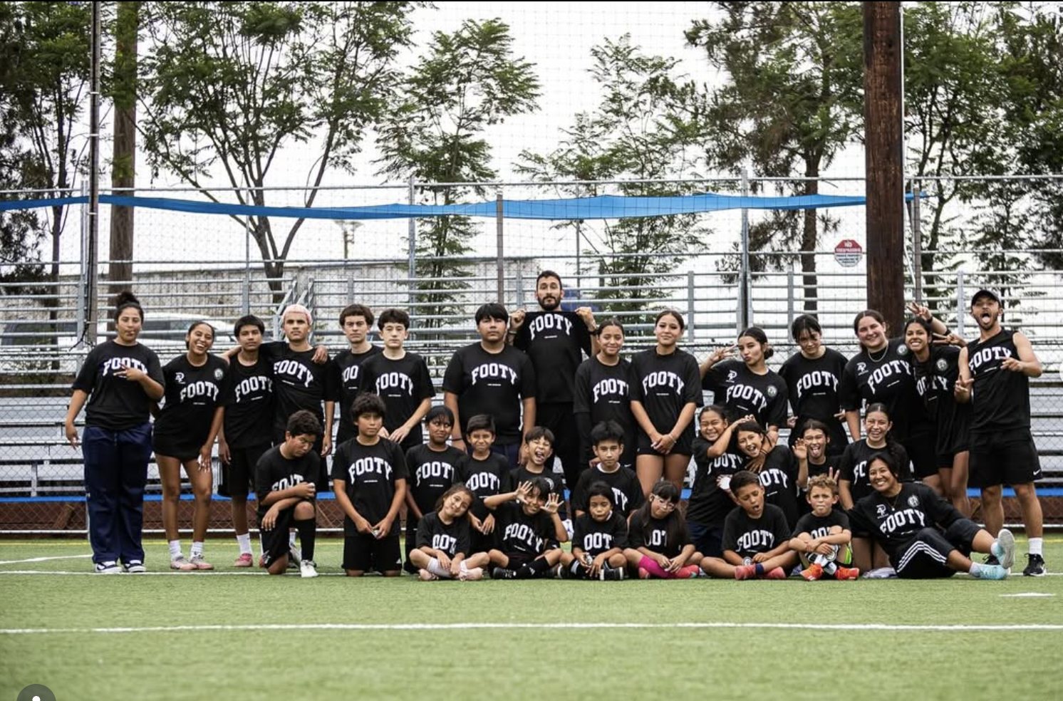 LTC Soccer players, kids, and coaches together on the field after a session
