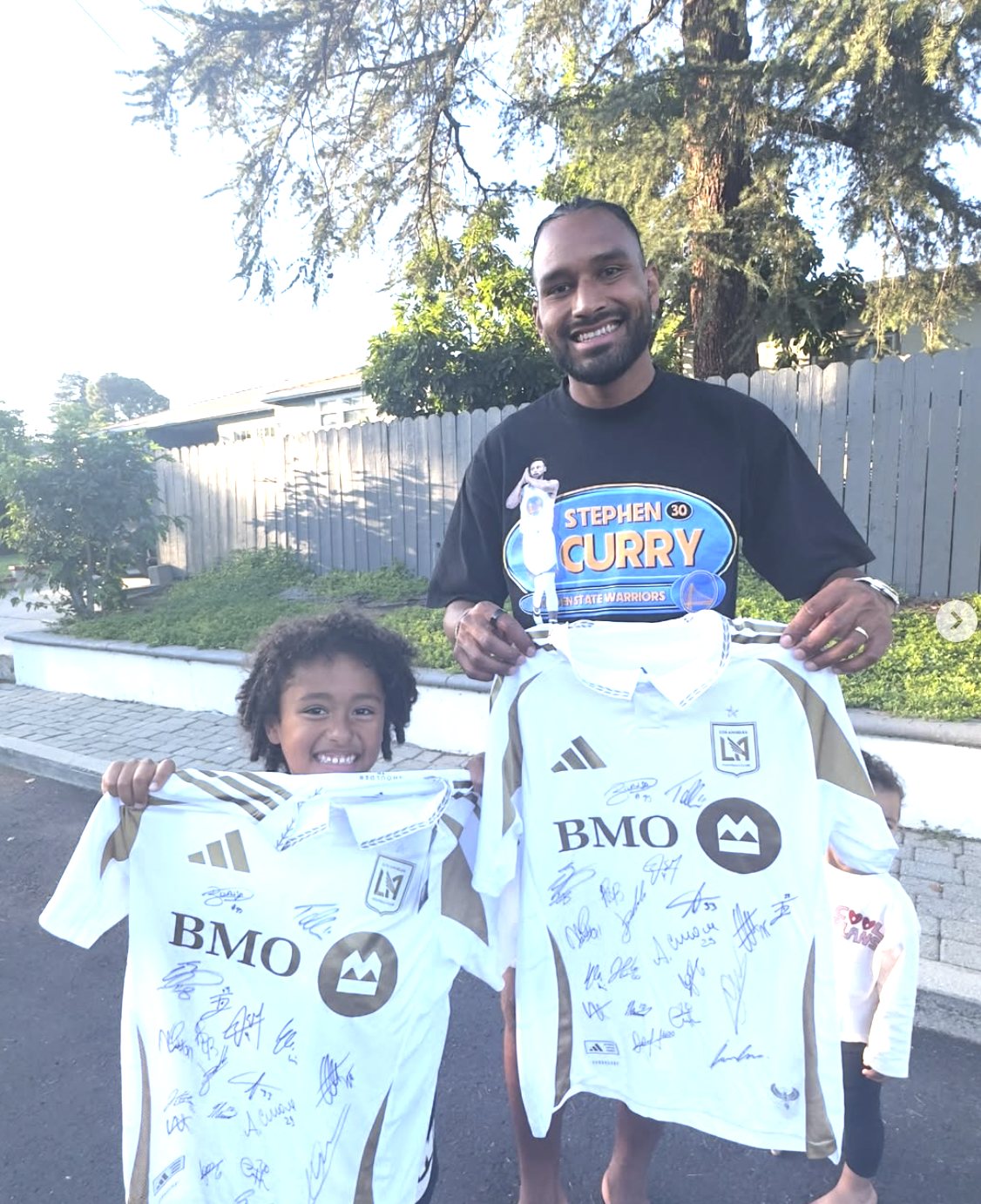 An LTC Soccer family with signed pro jerseys