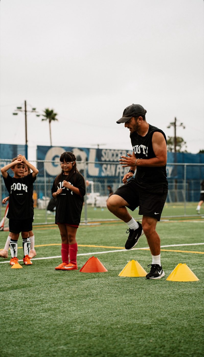 Agility work through the cones with the group watching